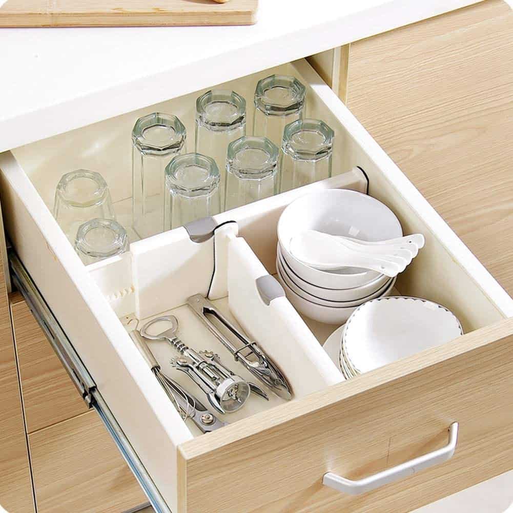 Adjustable kitchen drawer dividers with compartments for bowls, glasses and barware tools.