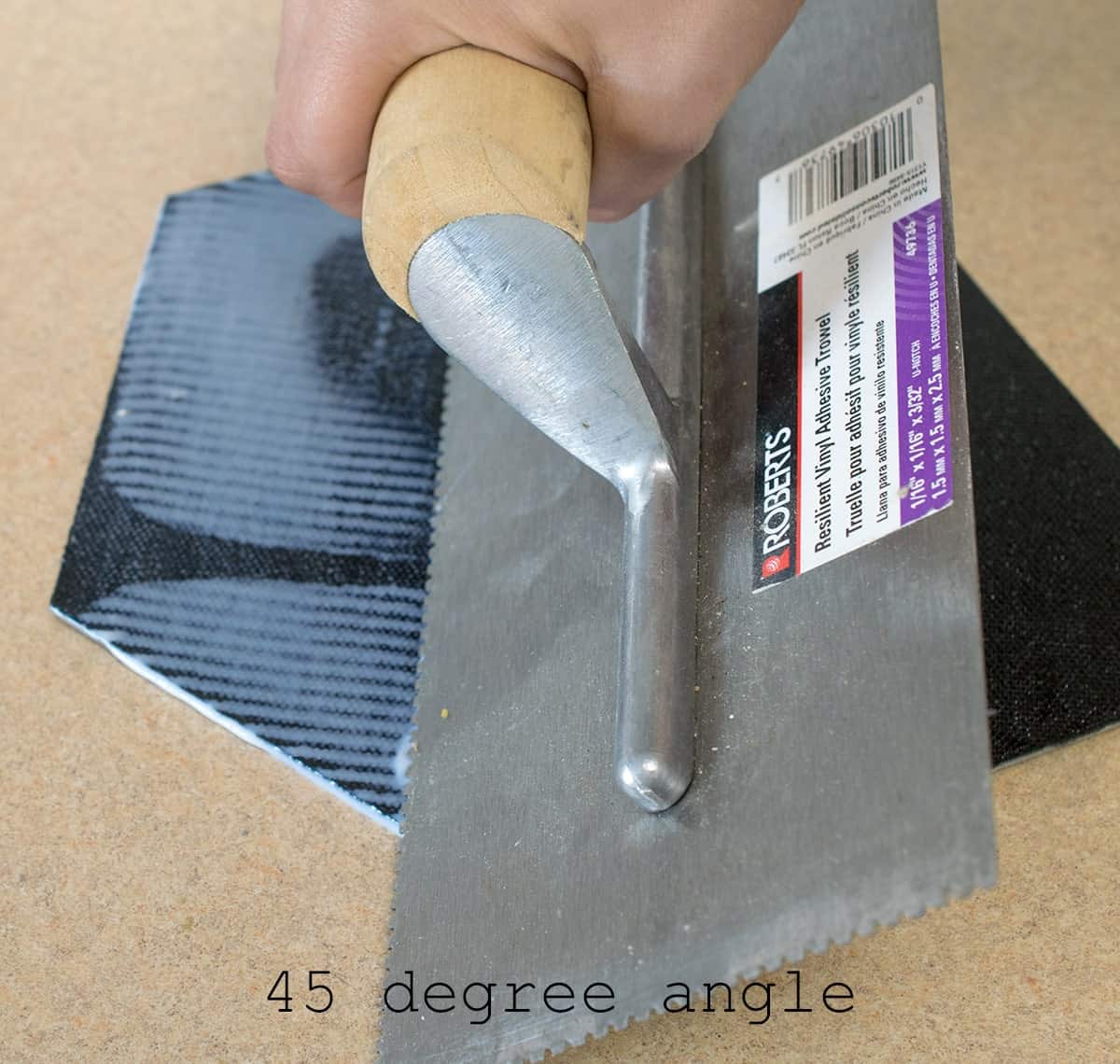 Applying adhesive to groutable peel and stick tile.