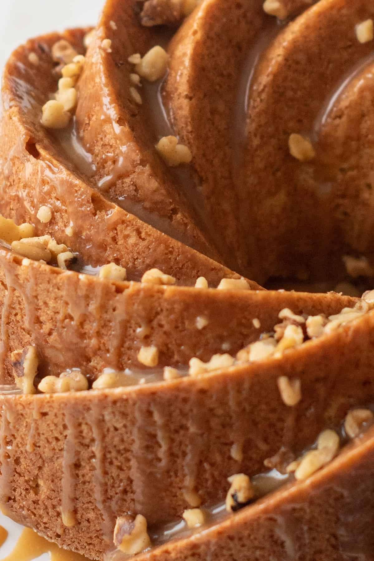 Close up of Bailey's cake. Bundt swirls, glaze topping and walnut pieces.