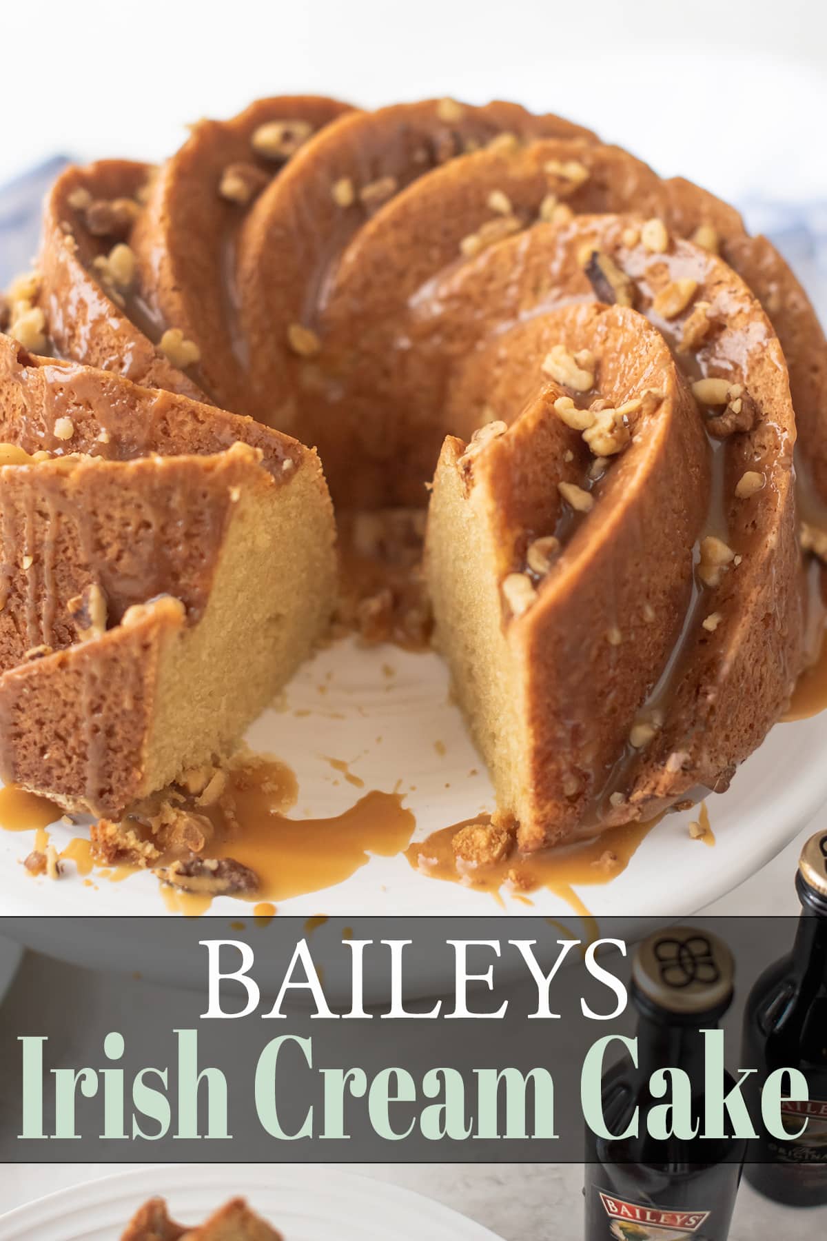 Bailey's Irish Cream Cake with slice cut out and topped with Bailey's glaze and walnuts.