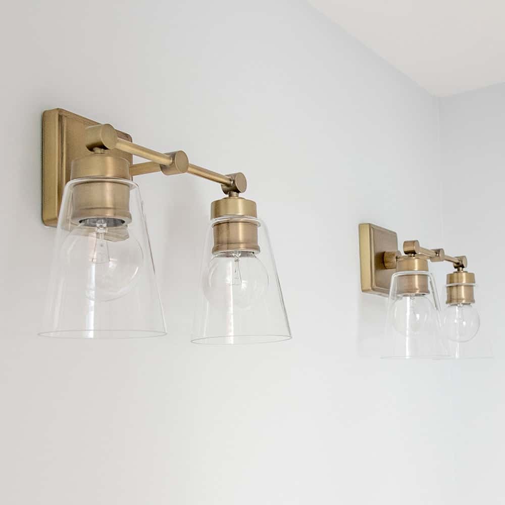 Vintage Modern styled dual vanity lights in aged brass for classic modern guest bathroom