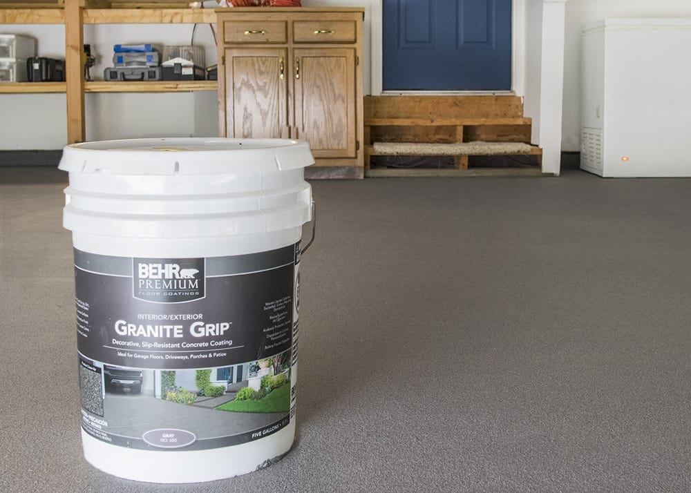 Garage floor with fresh coat of Behr Premium Granite Grip non-slip coating and a 5-gallon bucket of product.