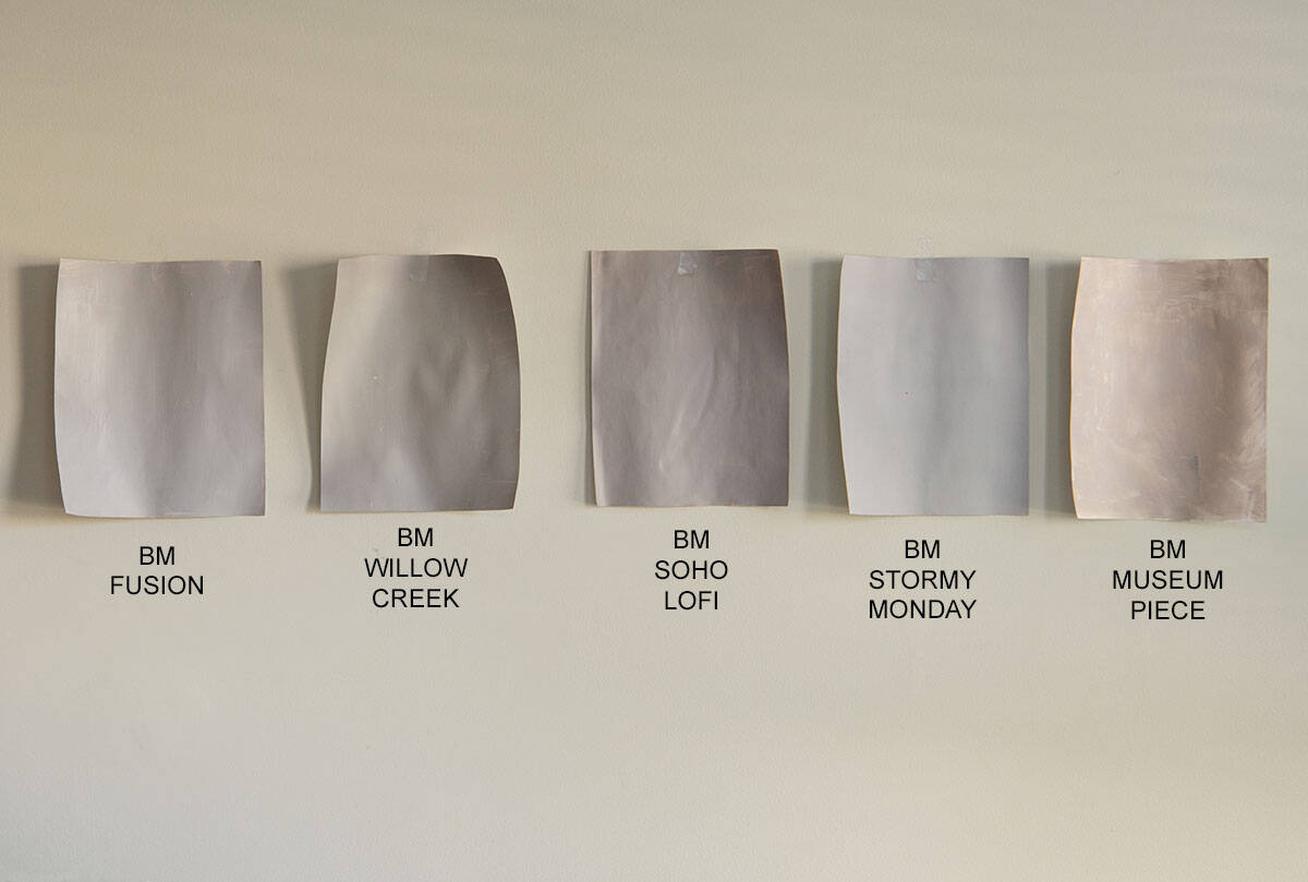 Five Benjamin Moore Gray paint samples next to each other including Fusion, Willow Creek, Soho LoFI, Stormy Monday, and Museum Piece.