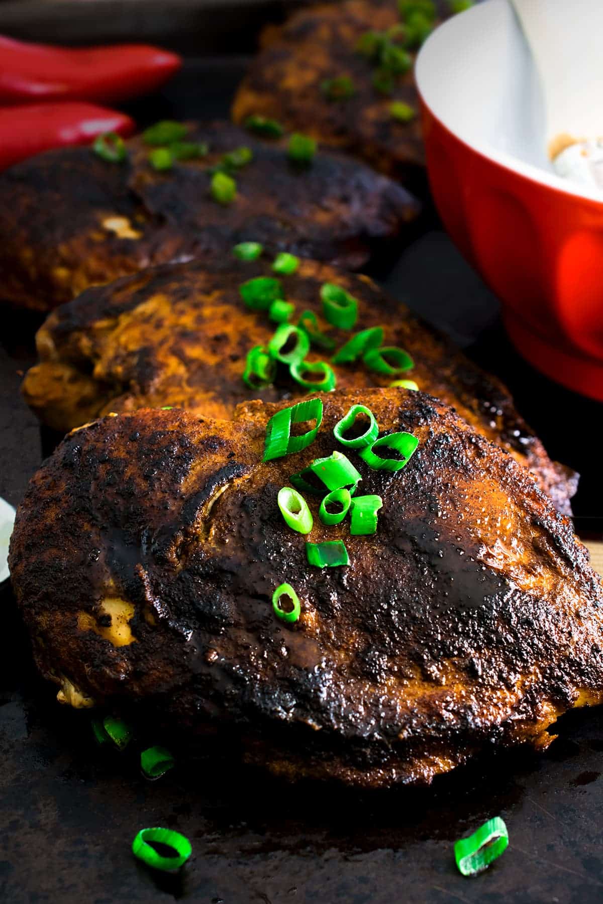Close up of Blackened Chicken with green onions on top for garnish.