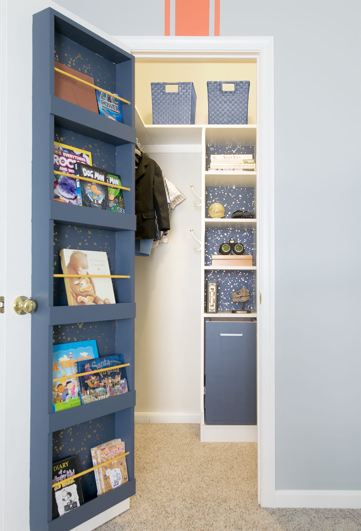 DIY custom closet makeover for a small closet for a toddler or kids closet featuring shelving, book storage, and bins.