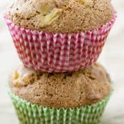 Two squash muffins stacked on top of one another in colorful wrappers.