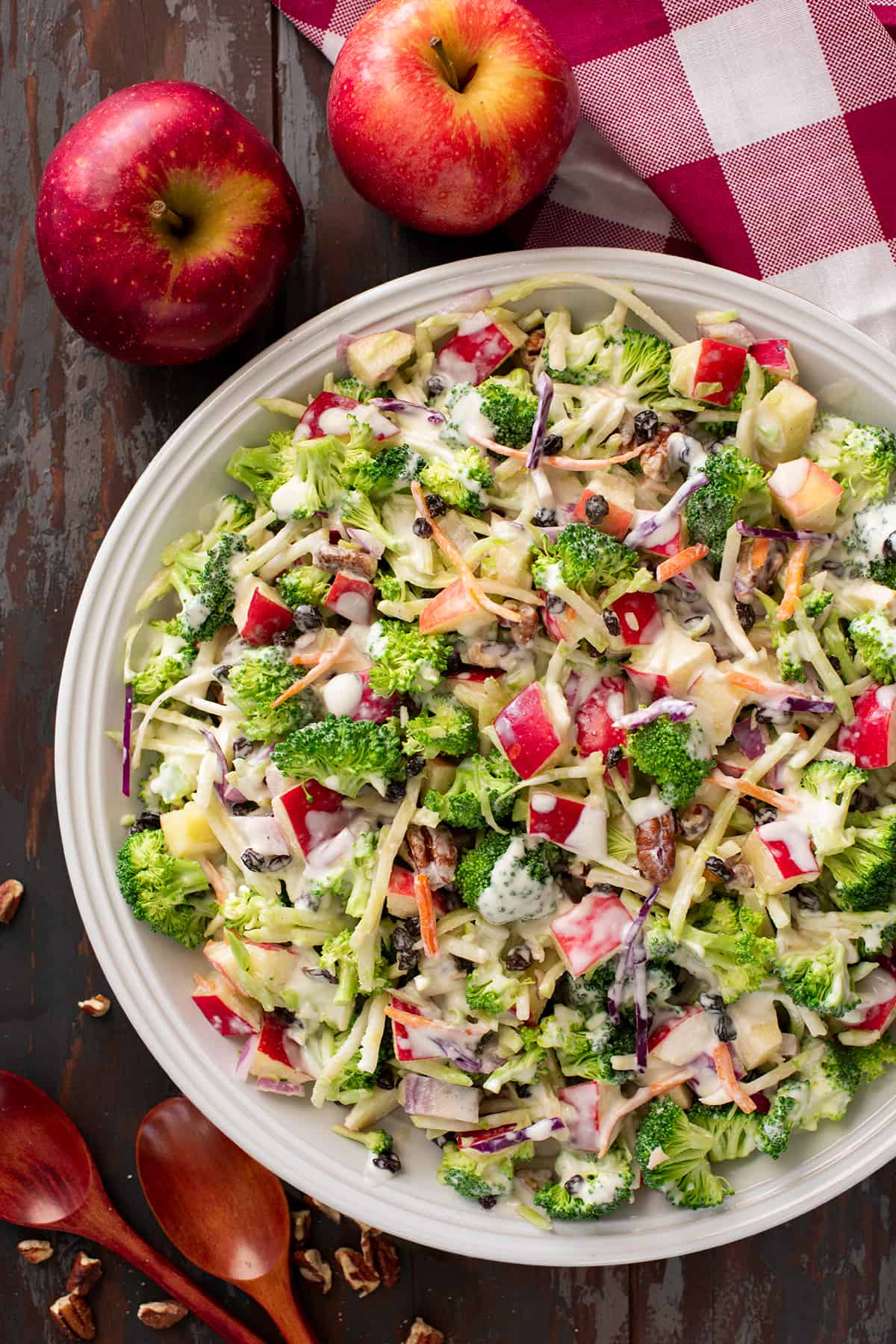 Broccoli apple salad in a bow with two apples on the side.