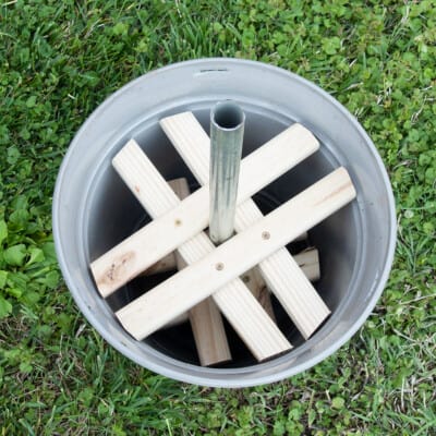 Planter pot braces with a pole for stability.