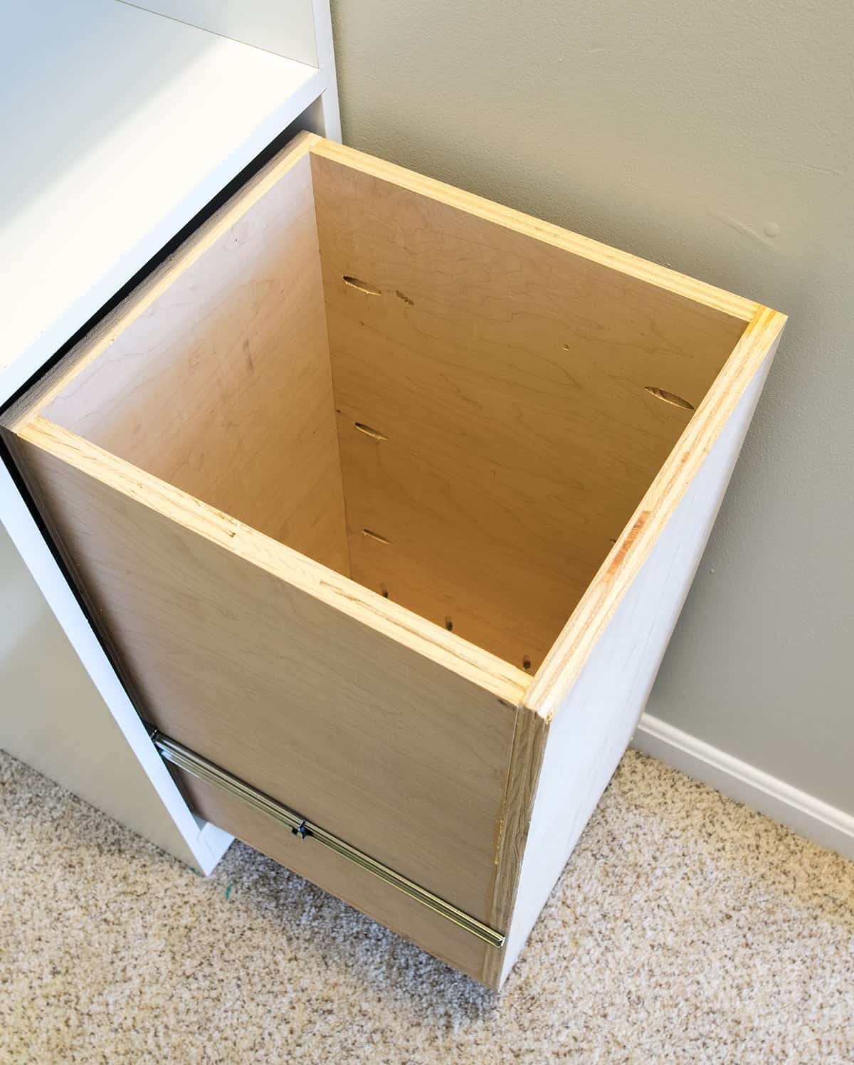 Built in laundry hamper with drawer slides.