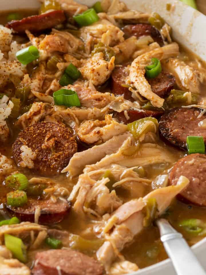 Closeup of chicken and andouille sausage gumbo in a bowl with rice.