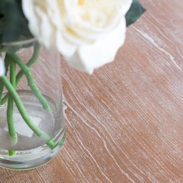 Cerused table top with white grain pattern.