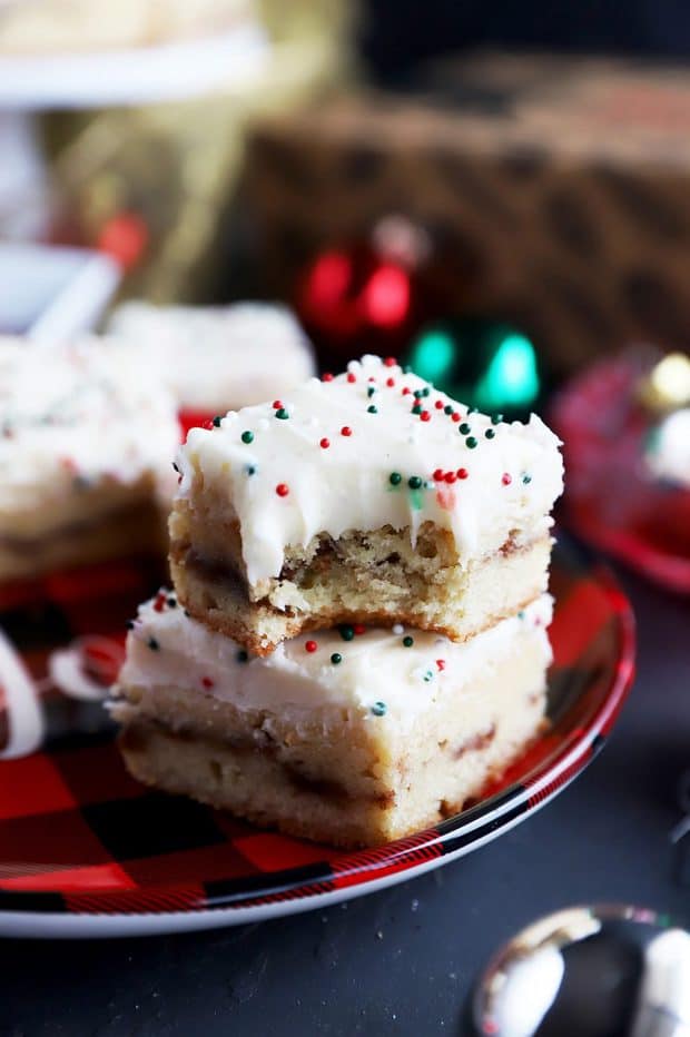Chewy snickerdoodle bars with eggnog frosting on a plate.