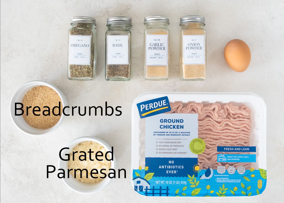 Chicken meatball ingredients laid out on a table with text labels.