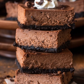 Chocolate Cheesecake Bars stacked four high.