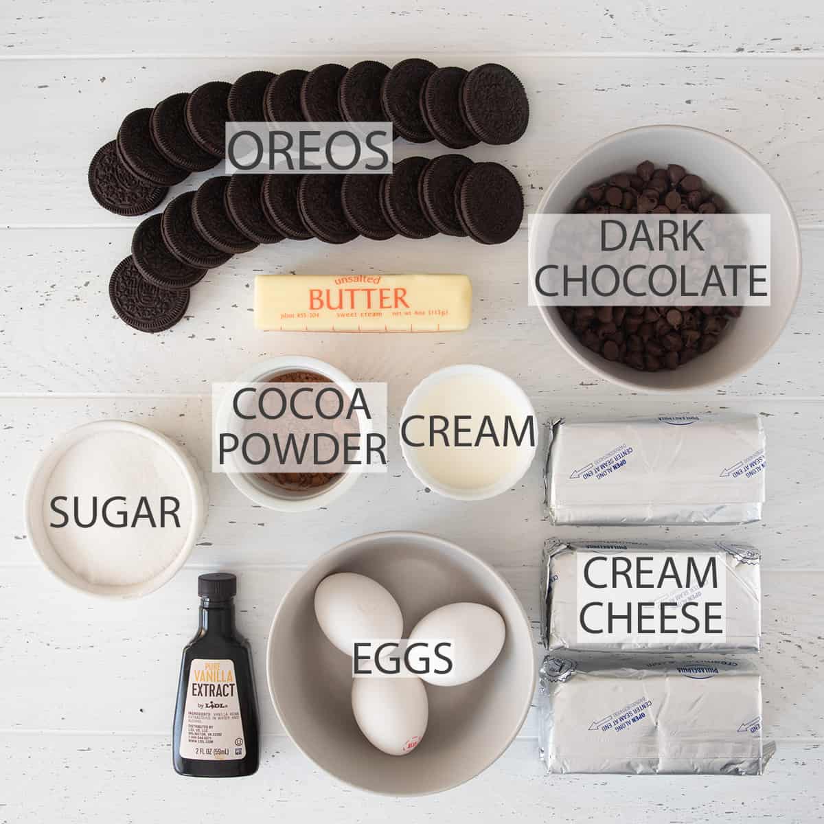 Ingredients for making chocolate cheesecake bars laid out on table.