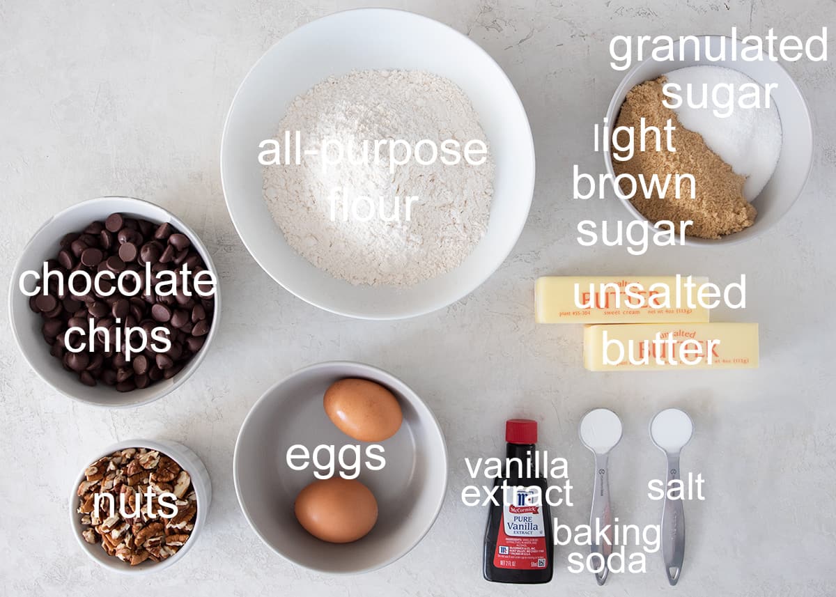 Chocolate chip cookies with nuts recipe ingredients laid out on a table with text labels.
