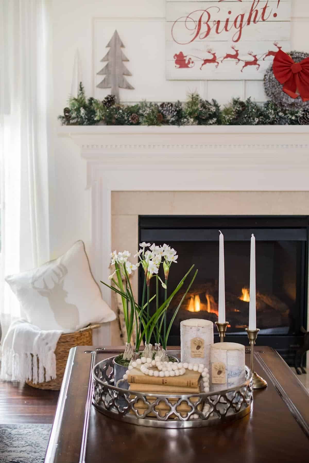 Neutral Christmas decor in the background of a coffee table styled for the holidays with paperwhites