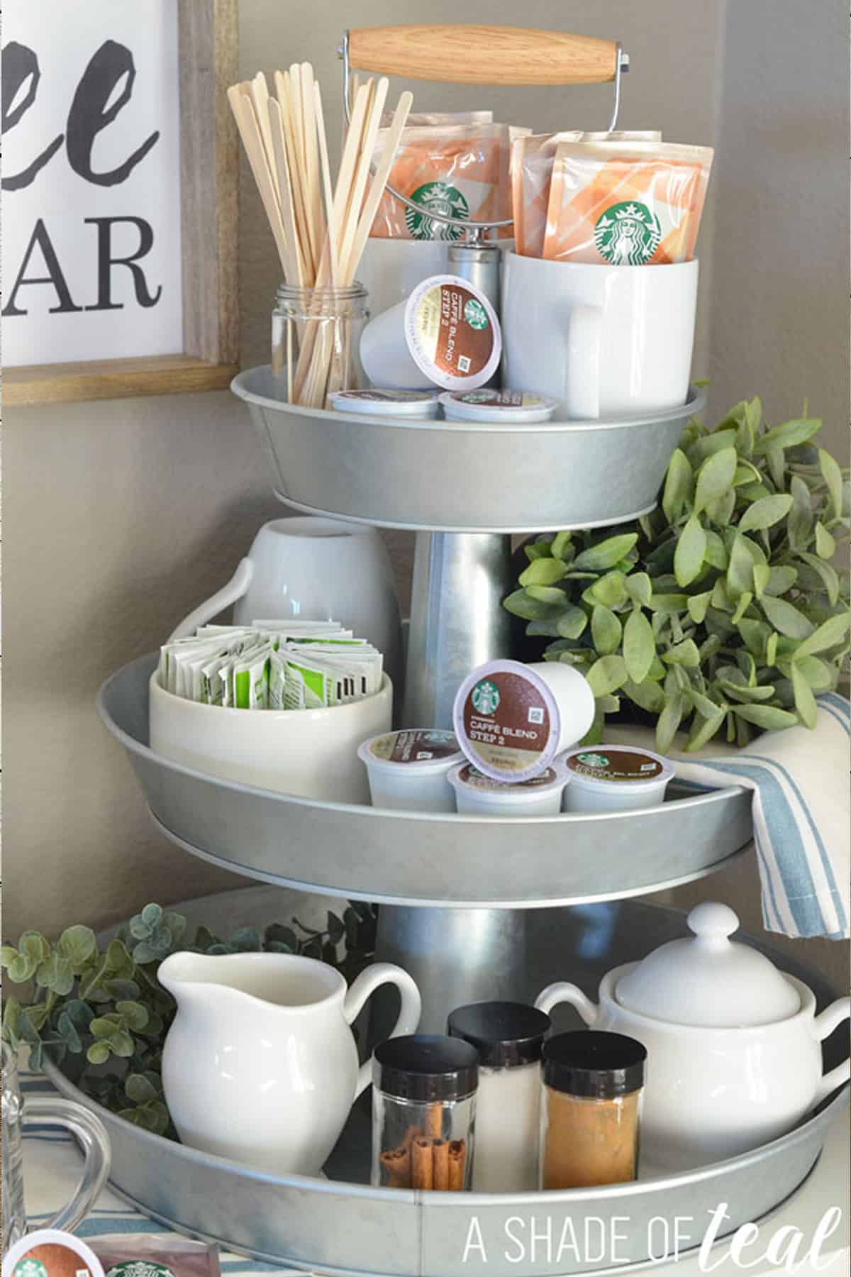 A coffee bar serving tray with cups, cream, k-cups, and coffee supplies for the morning.