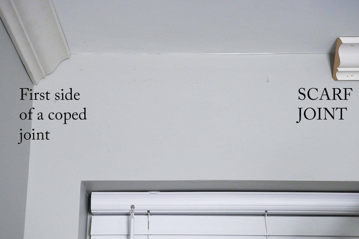 A corner wall with one side of the crown molding waiting for a coped joint to be made.