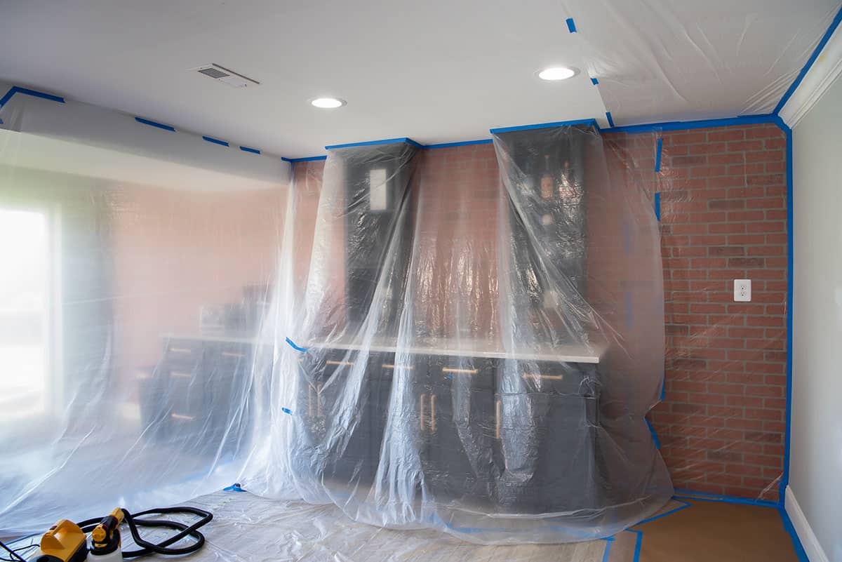 Cabinets with plastic sheeting over them.