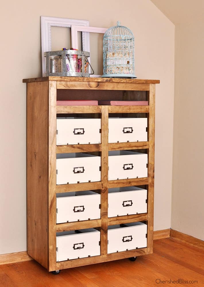 DIY shelves with crates and labels for an organized office space perfect for organizing your craft room efficiently.