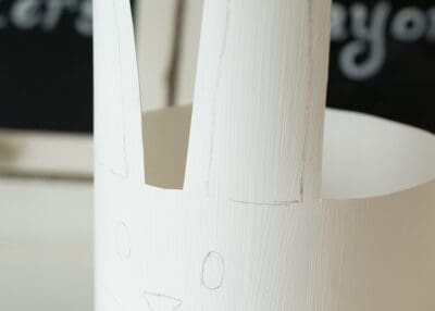 Cutting a plastic bottle into the shape of a rabbit.