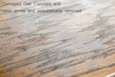 Damaged oak kitchen cabinet surface closeup.