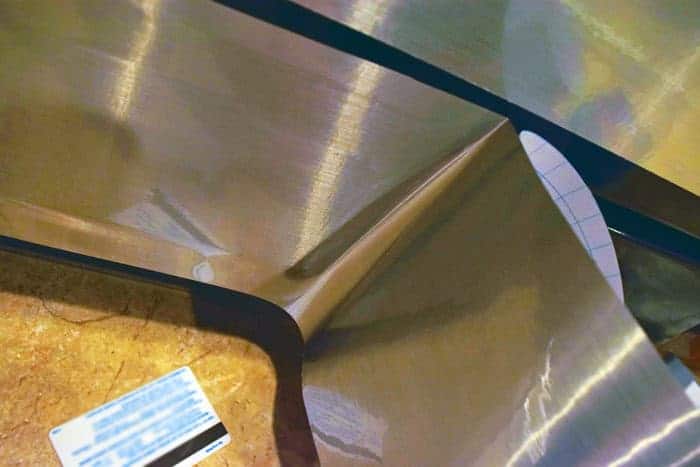 In progress of applying faux stainless steel contact paper to black dishwasher. 