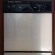 Dishwasher with DIY stainless steel contact paper applied for budget friendly kitchen makeover.