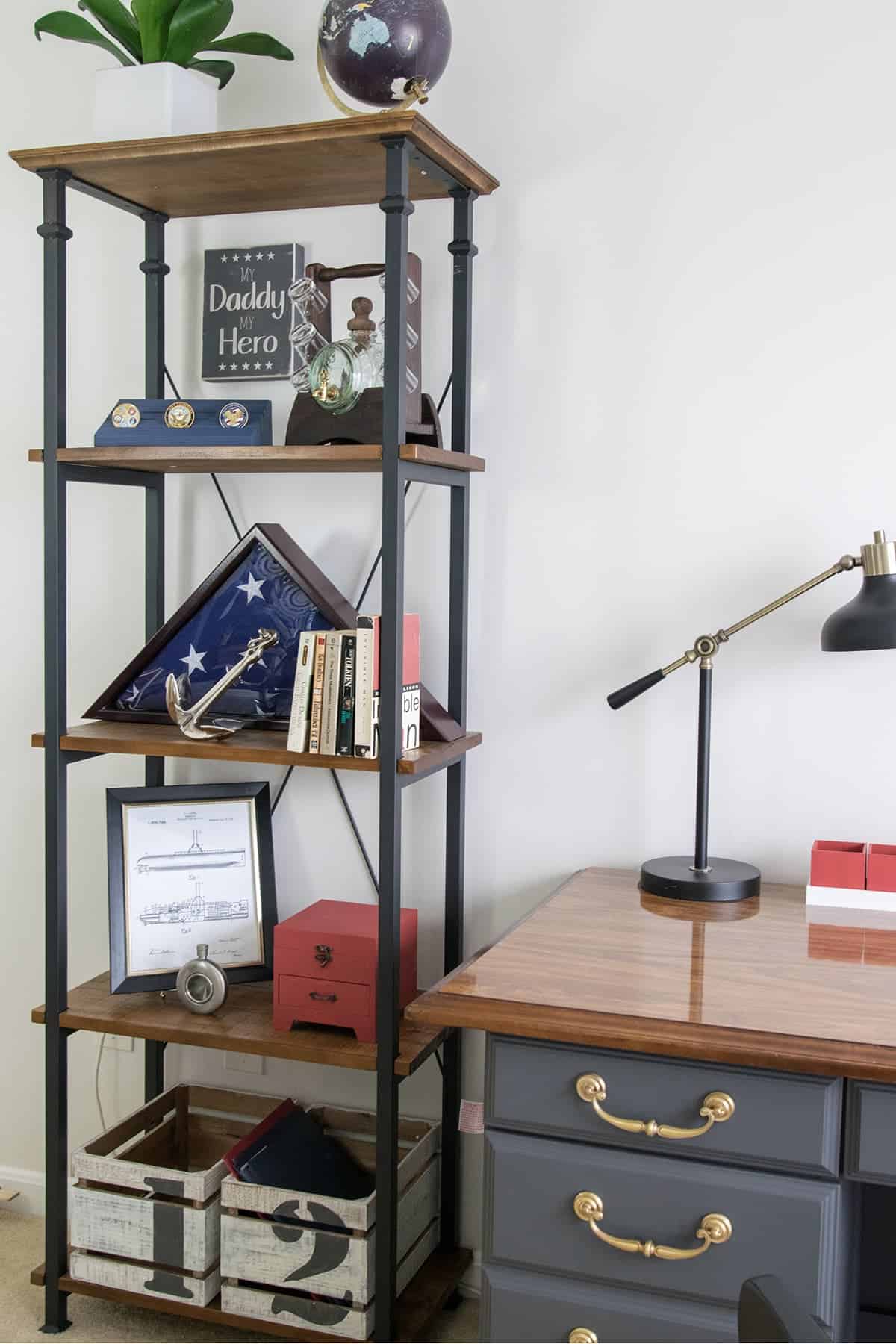 Free standing shelf display in office setting with collection of patriotic and masculine items.
