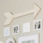 DIY arrow wall decor hanging in a gallery wall,