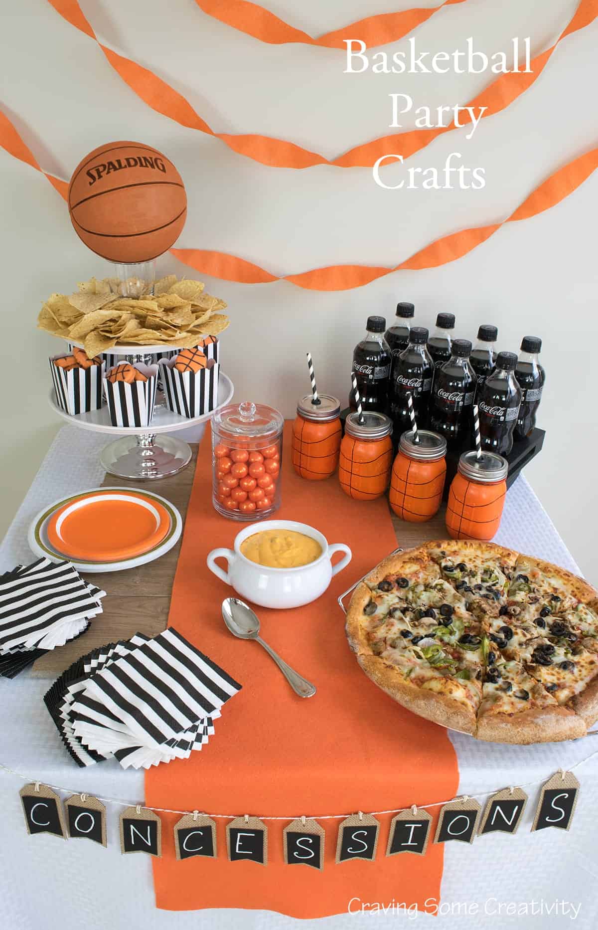 Basketball themed birthday party table with DIY crafts and orange and black color scheme. 