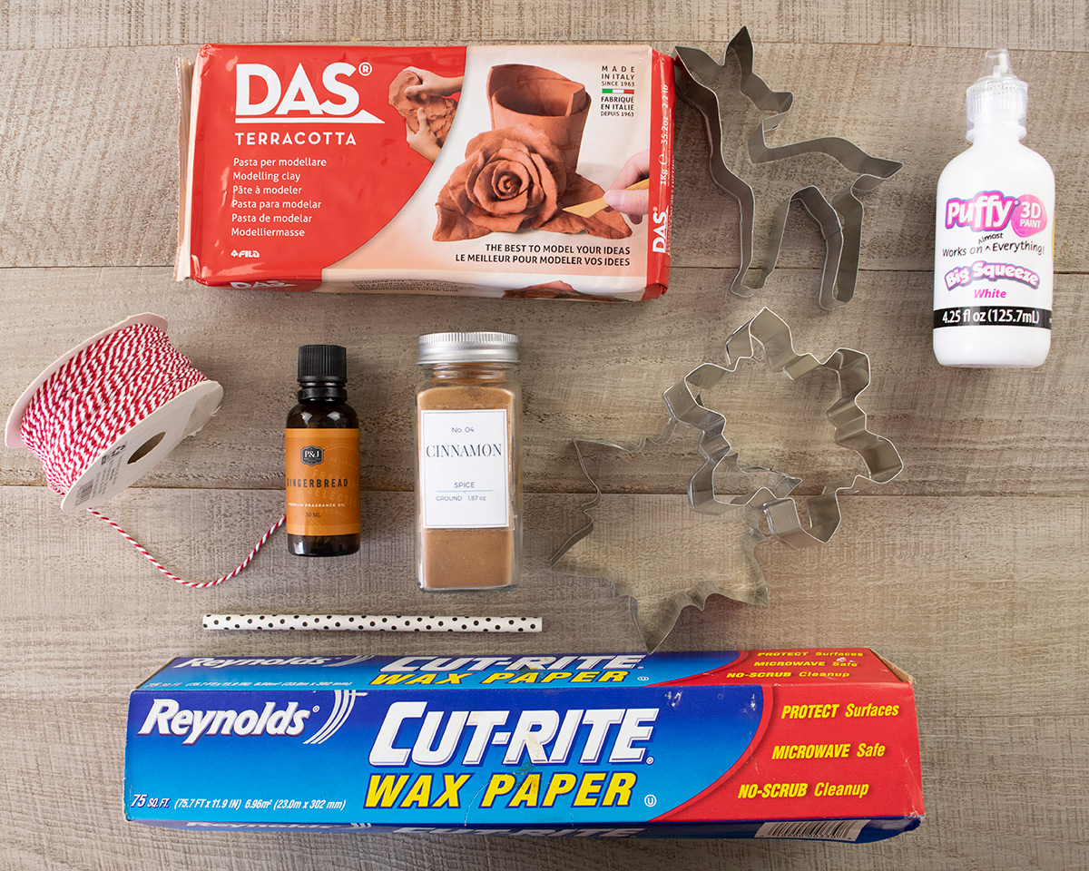 Supplies to make gingerbread ornaments laid out on a table.