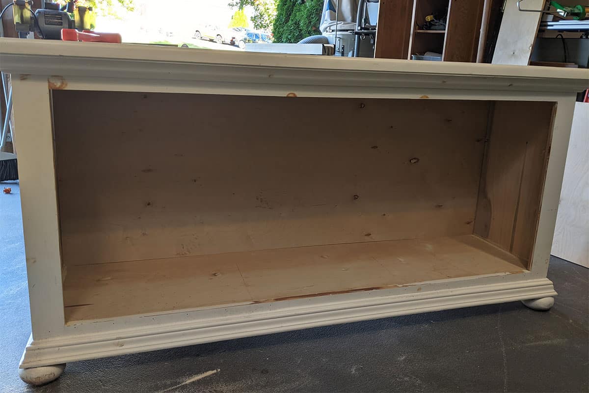 A gutted tv stand from a dresser being built.