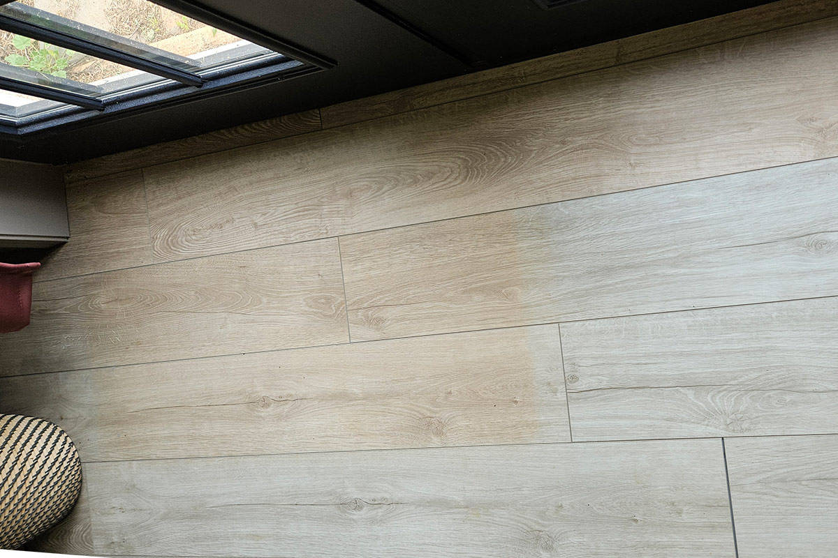 A vinyl plank floor that has faded in direct sunlight.