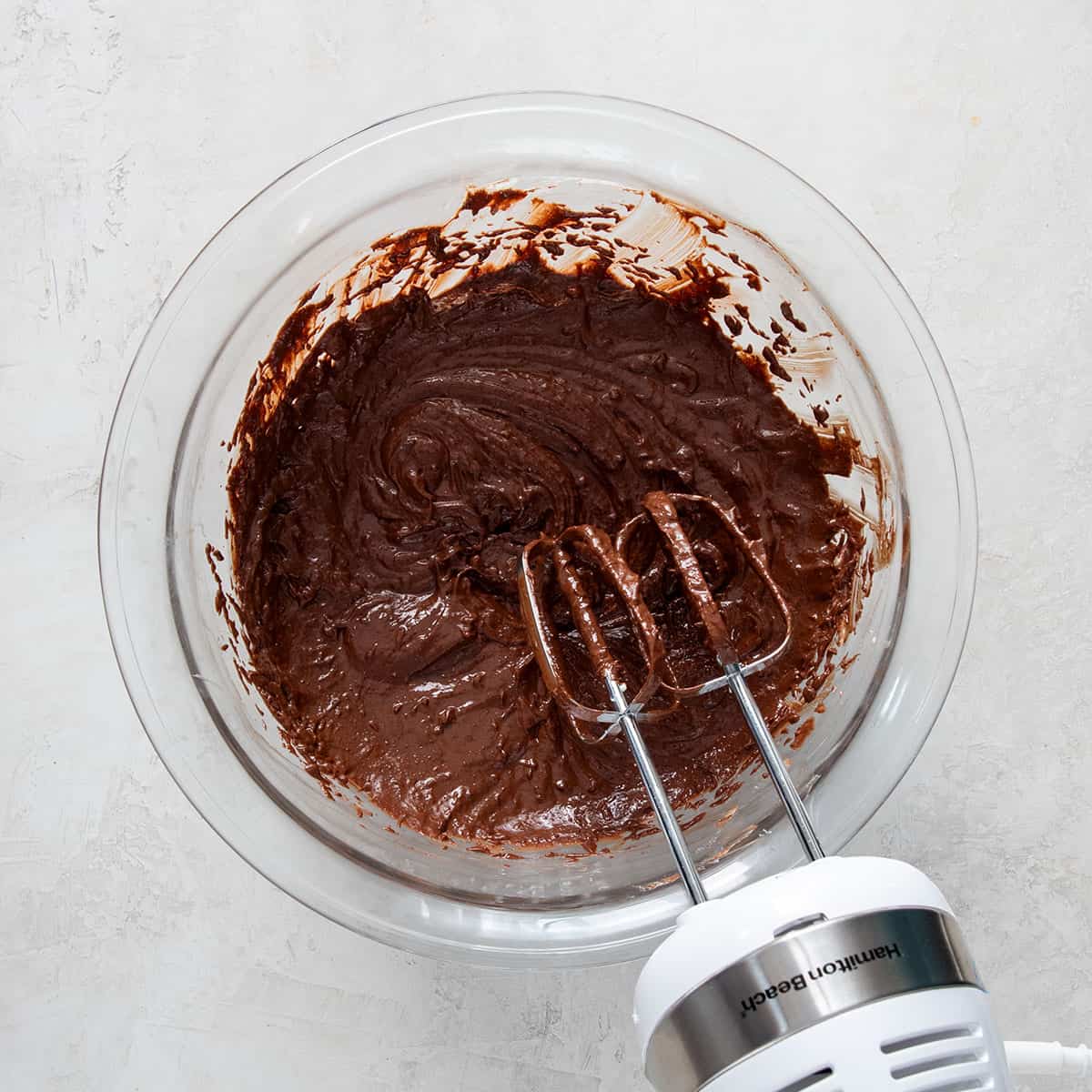 Flat lay of chocolate cake batter in a bowl after wet ingredients are mixed.