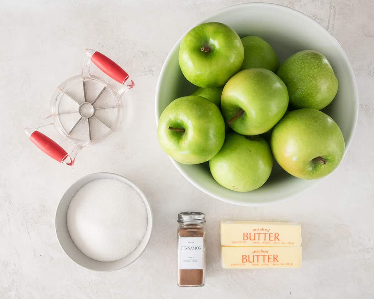 Ingredients to make fried apples laid out on a table.