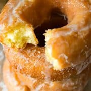 Closeup of stack of old fashioned doughnuts with the top broken in half.