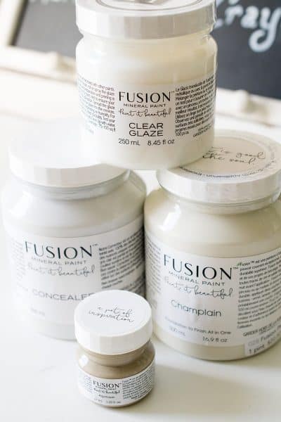 Stacked jars of Fusion mineral paint in Champlain, Algonquin and clear glaze.