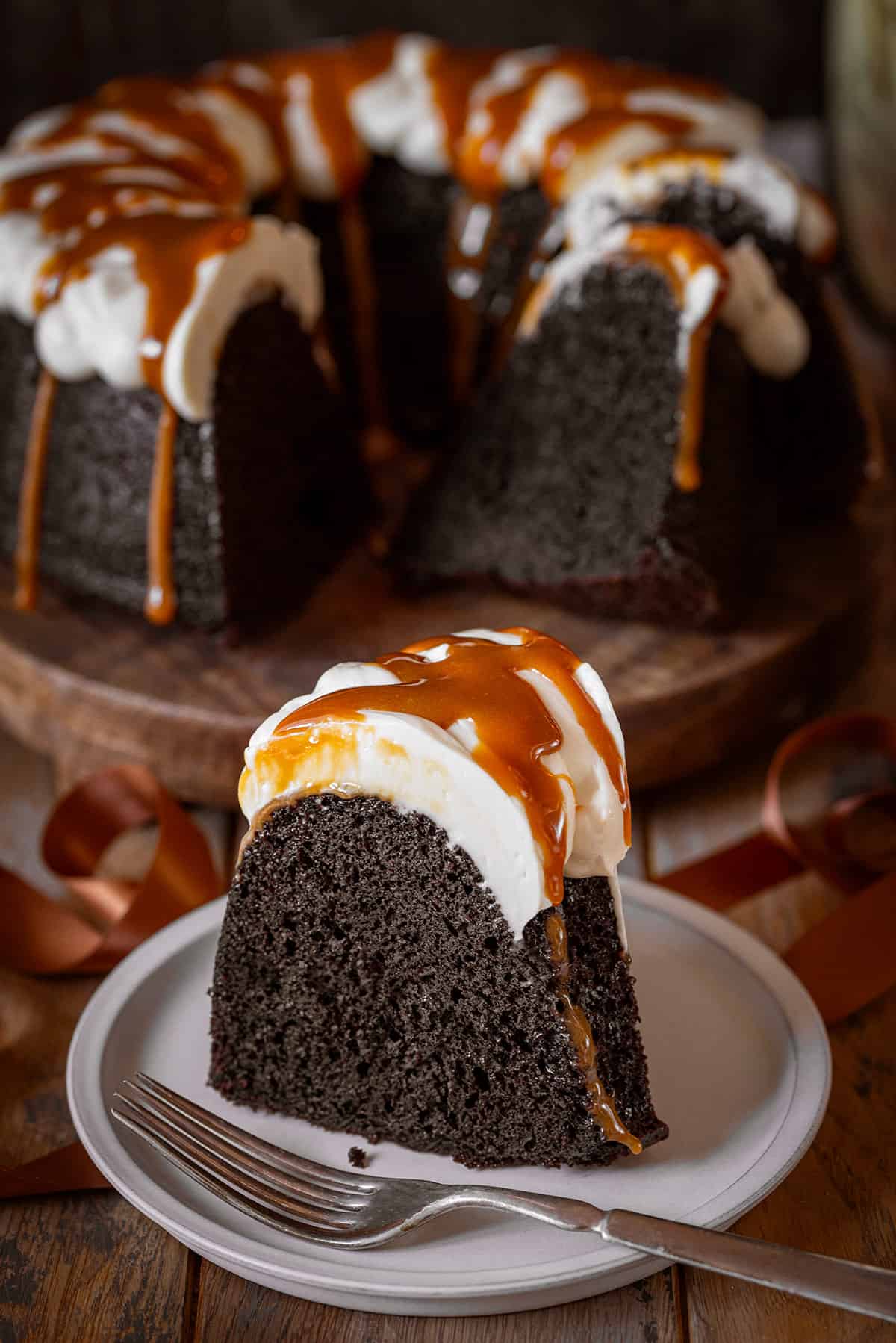 A slice of Guinness chocolate cake with white frosting to look like a pint.
