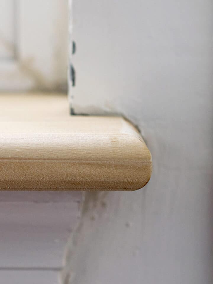 Top down view of a pet damaged wood window sill before repair.