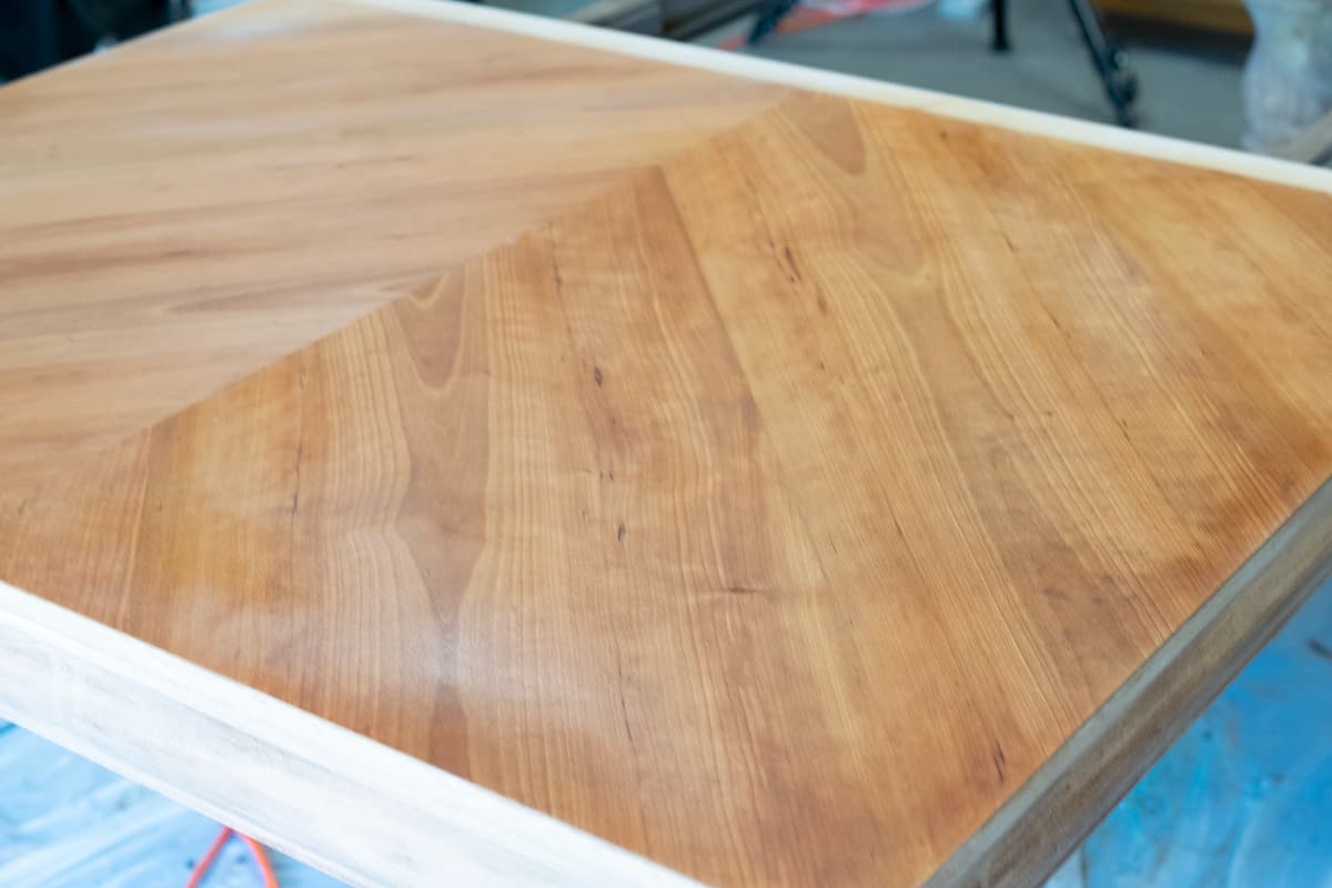 In process photo of bleaching a wood tabletop to create a raw wood finish.