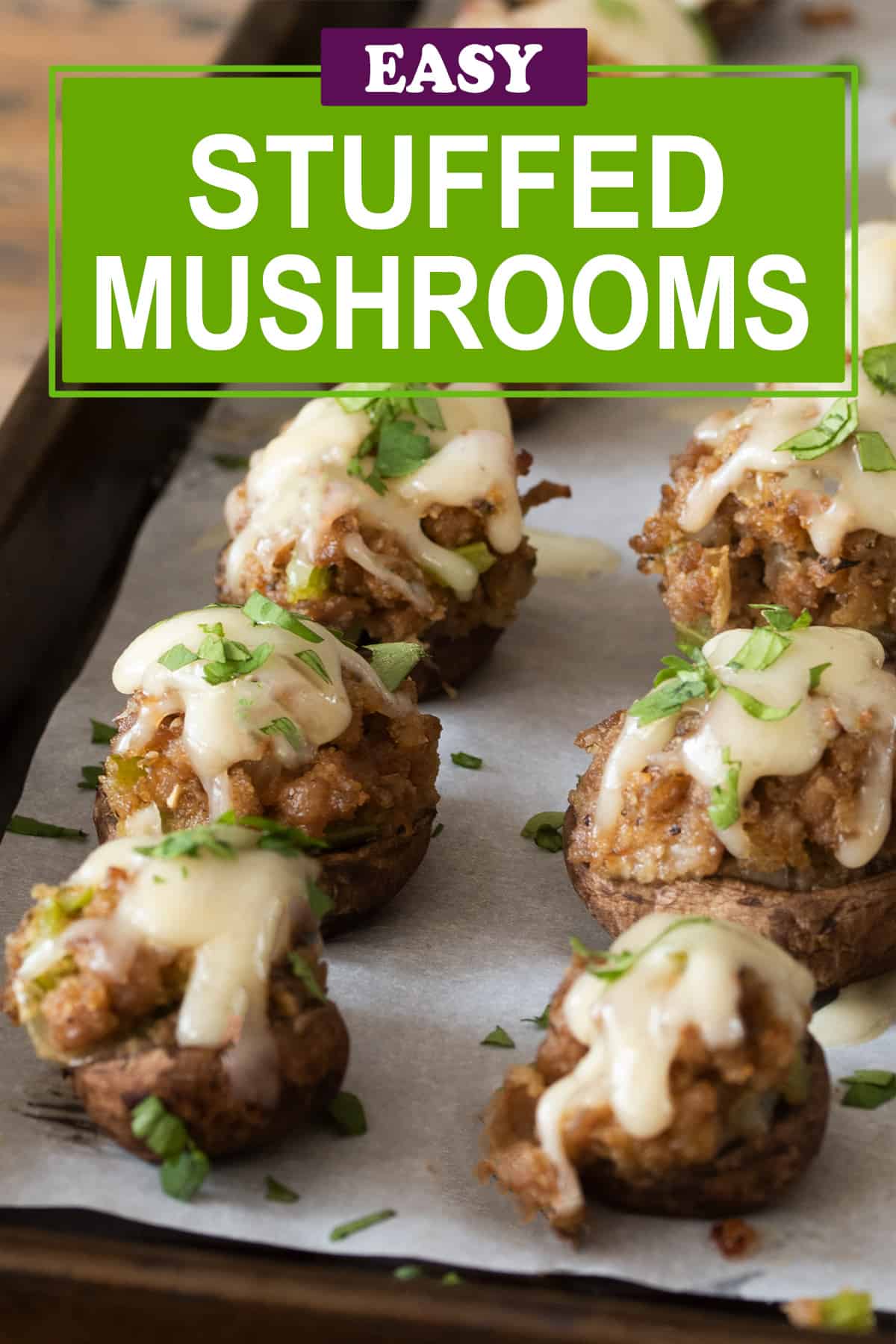Baked stuffed mushrooms with sausage and cheese on wood cutting board