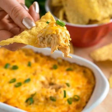 Buffalo Chicken dip being scooped on a tortilla chip.