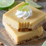 Two slices of lime bars with a bite removed.