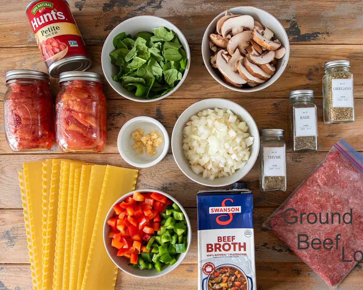 Ingredients to make lasagna soup laid out on a table.