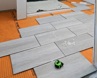 Floor tile laid out to dry fit and plan layout for cuts and pattern.