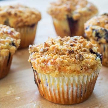 Closeup of blueberry muffins on a table.