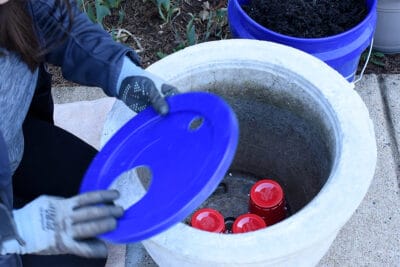 Woman laying the platform to make a self-watering planter.