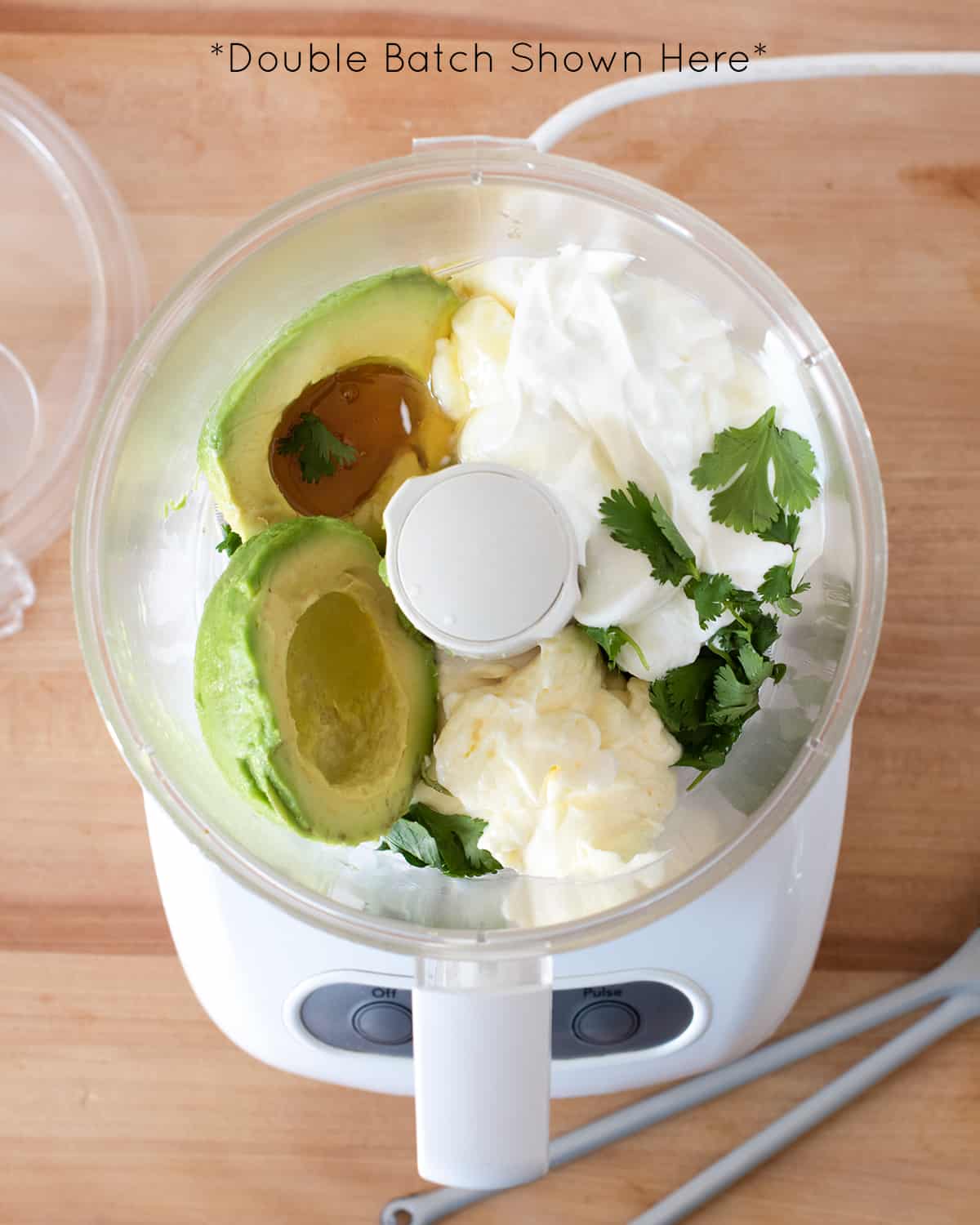 Looking into food processor with ingredients for sauce before they are blended.